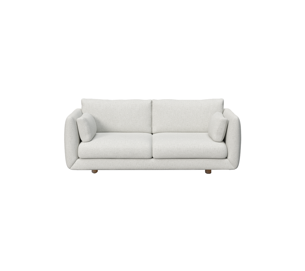 Ljusgrå soffa med rundade kuddar i en modern, minimalistisk stil.