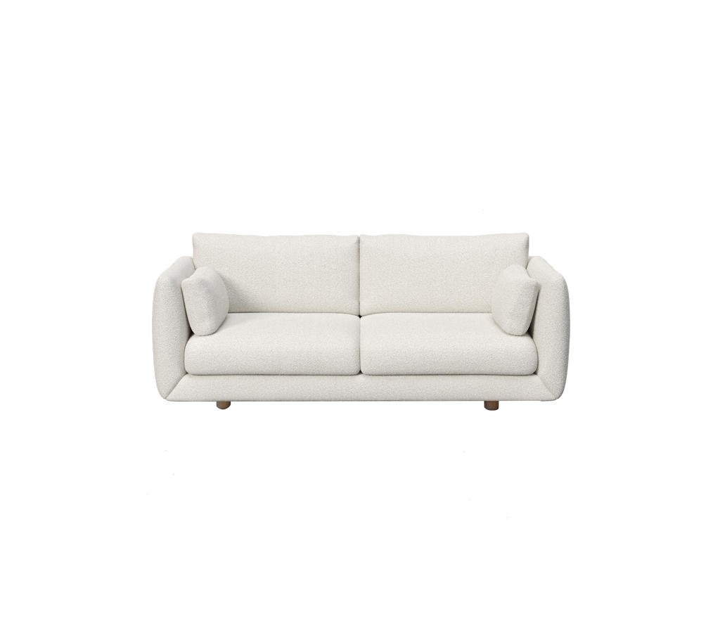 Modern vit soffa med två kuddar.