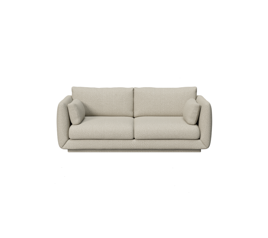 Ljusbrun soffa med runda kuddar i en modern design.