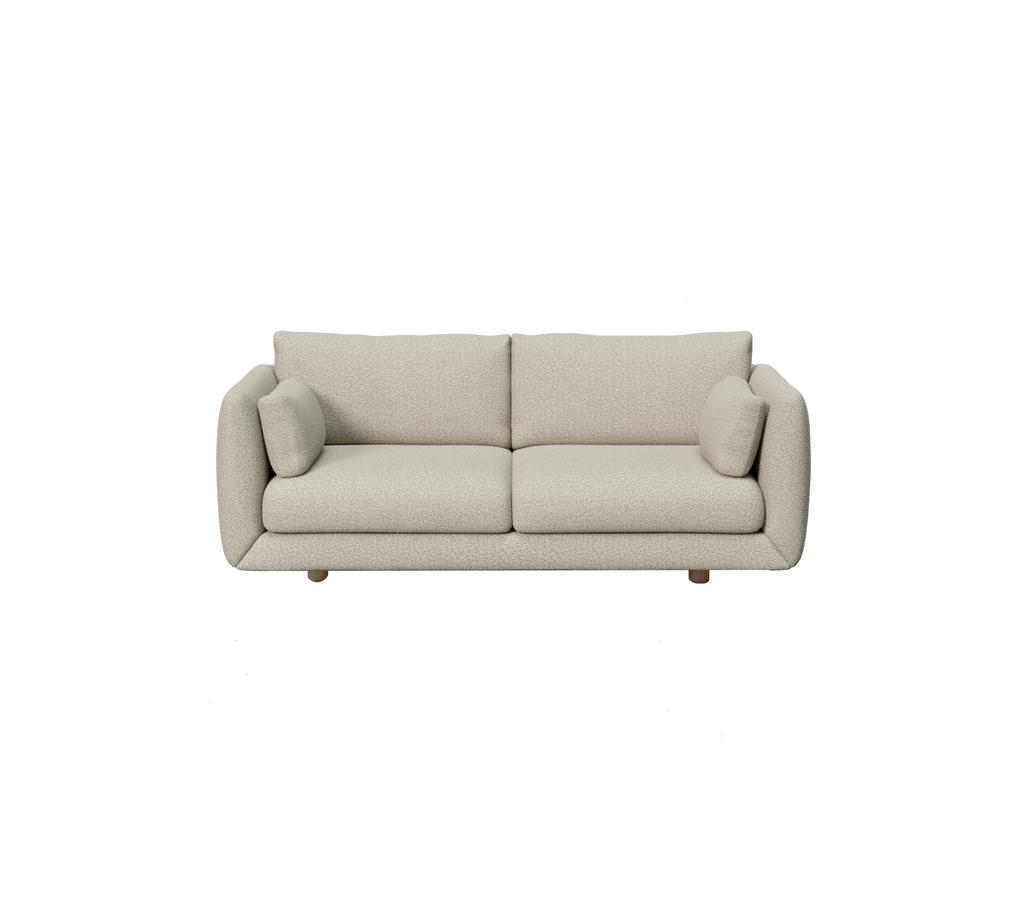 Ljusbrun modern soffa med runda kuddar i en minimalistisk stil.