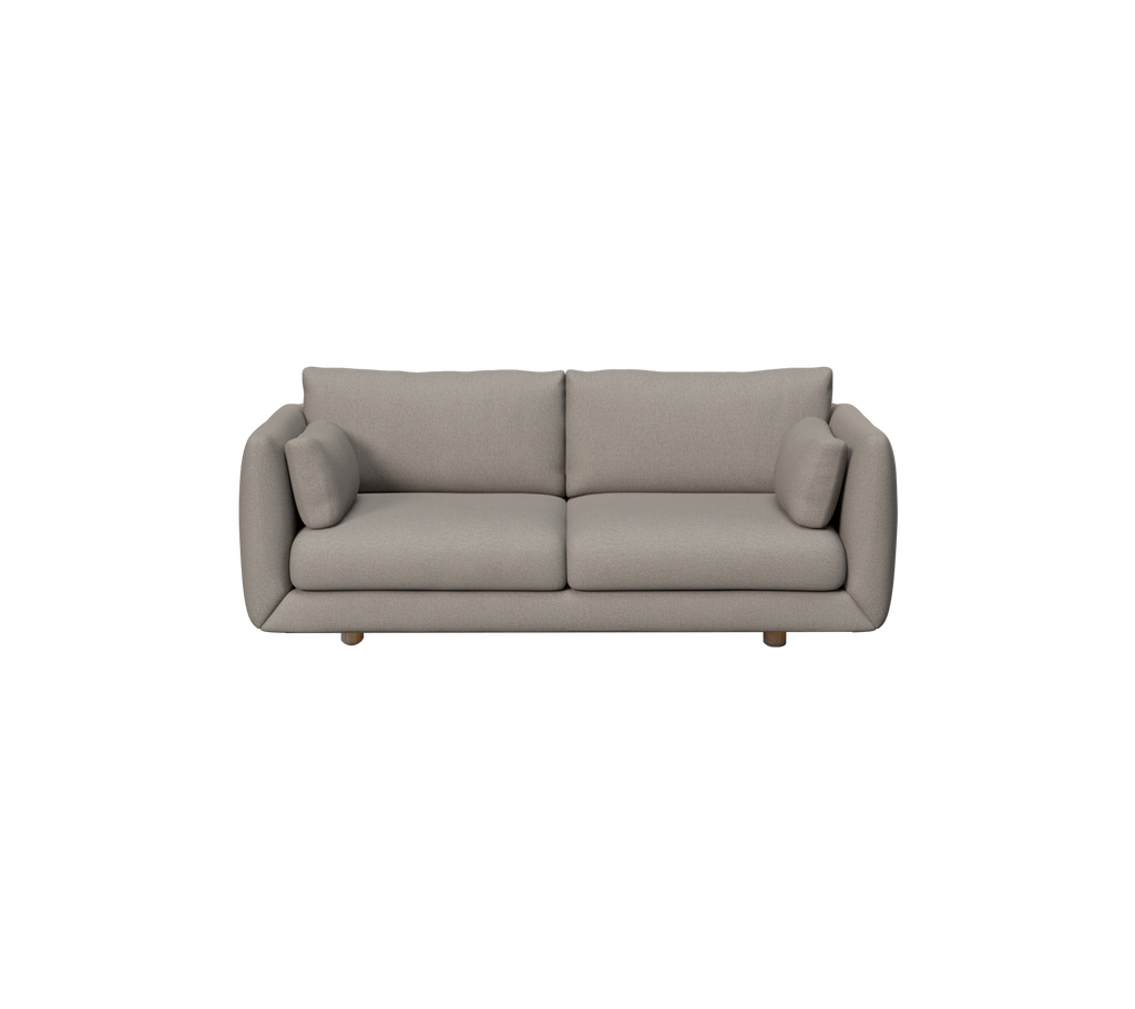 Ljusbrun modern soffa med rundade kuddar i en loungeinredning.