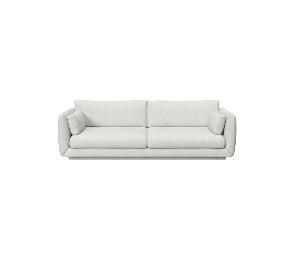 Ljusgrå soffa med två runda kuddar i modern design.