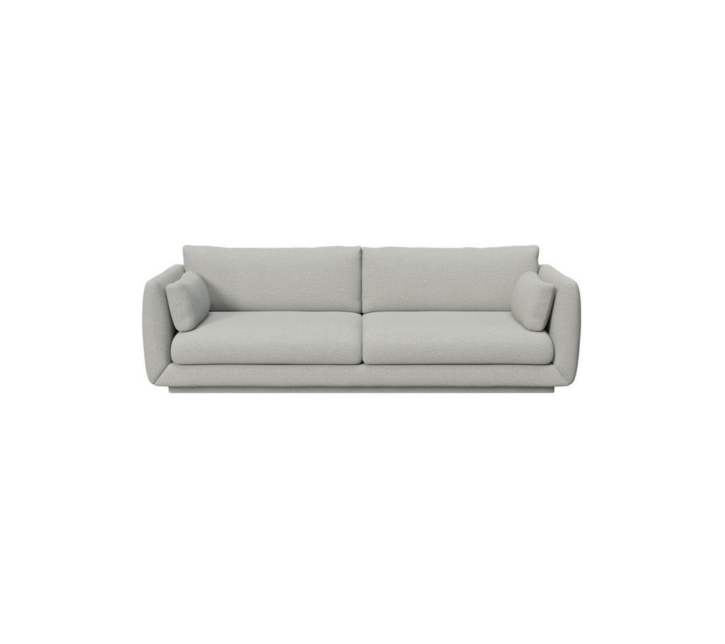 Ljusgrå modern soffa med runda kuddar.