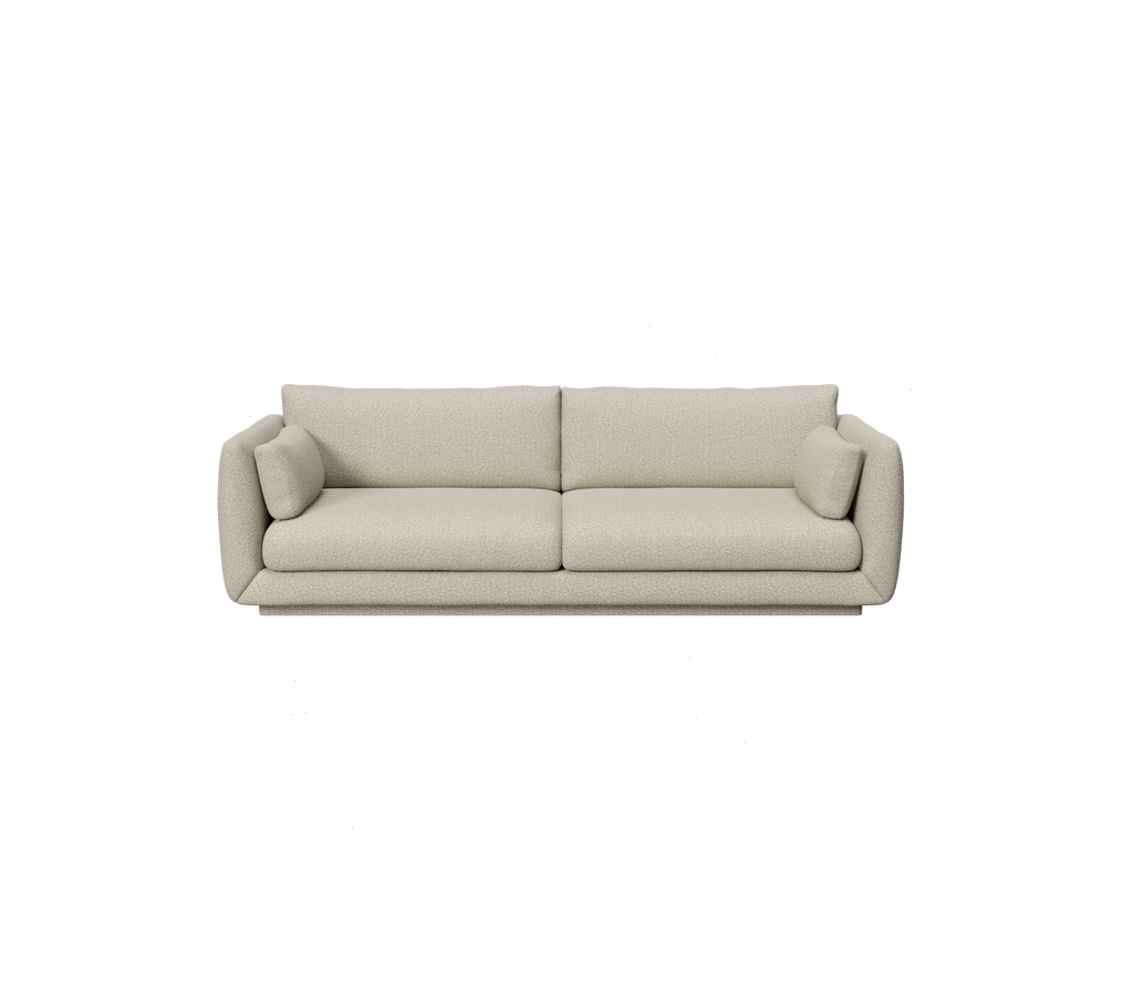 Ljusbrun modern soffa med rundade kanter och kuddar.