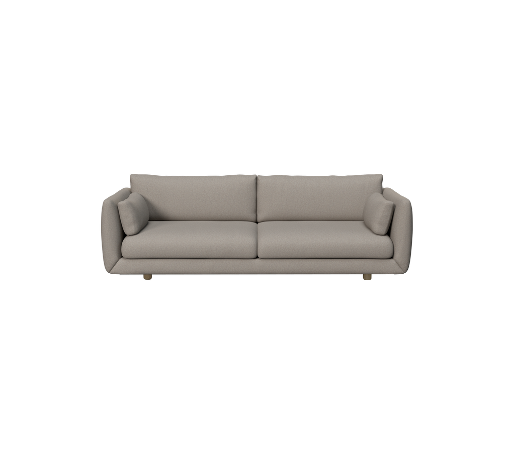 Ljusbrun modern soffa med sidokuddar.