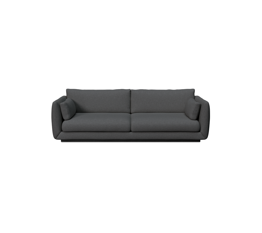 Modern mörkgrön soffa med en smidig design och bekväma kuddar.