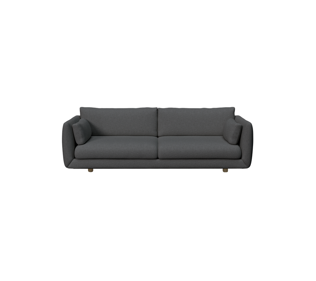 Mörkgrön modern soffa med mjuka kuddar.