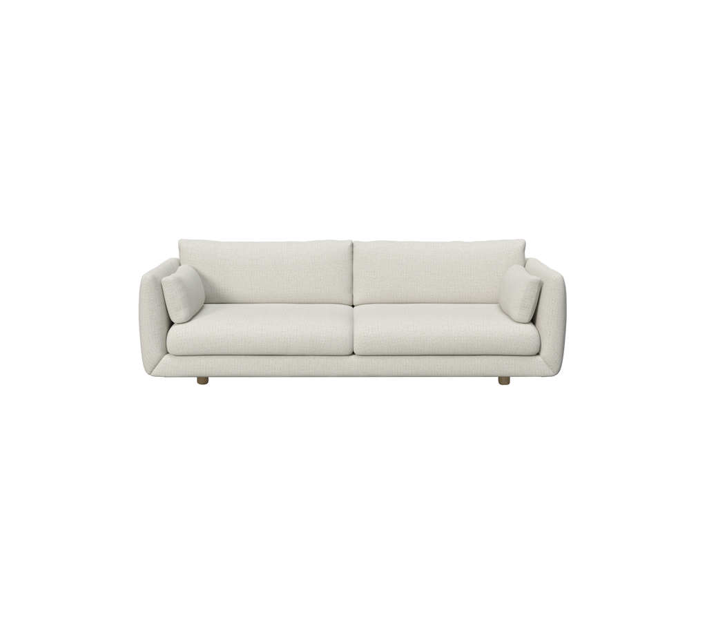 Modern sandfärgad soffa med runda kuddar.