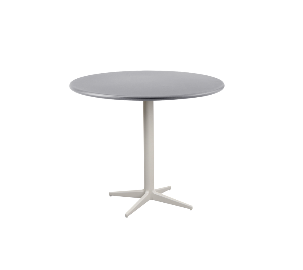 Modernt runt bord med en slät grå topp och en robust, ljusbas med ett fyrbent design.