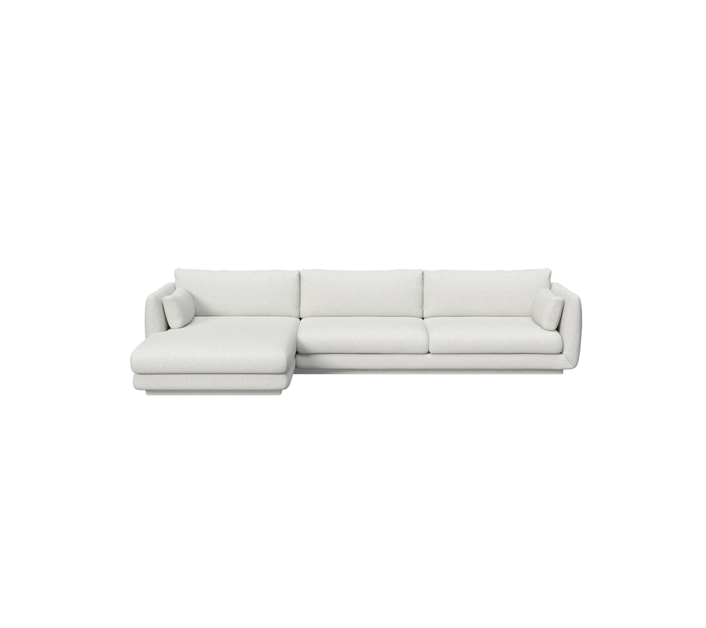 Ljusgrå sektion sofa i en modern loungemiljö.