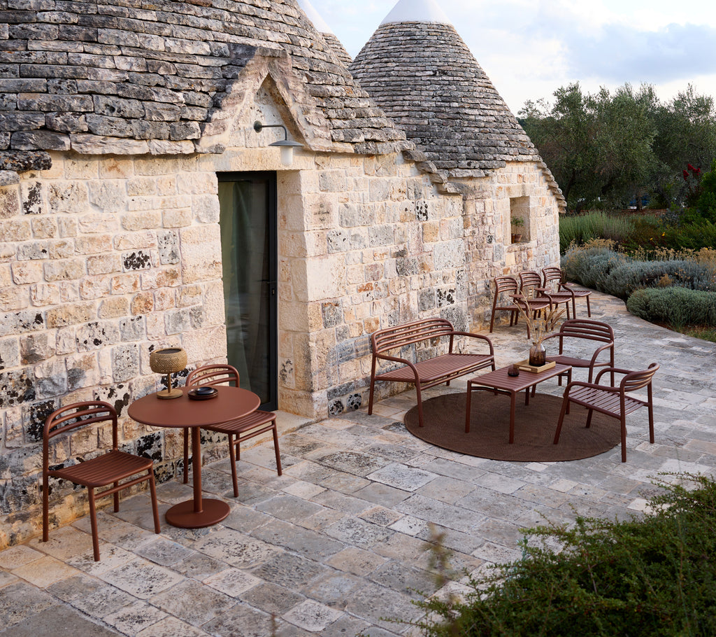 Utomhusmiljö med ett brunt bord och stolar i modern design.