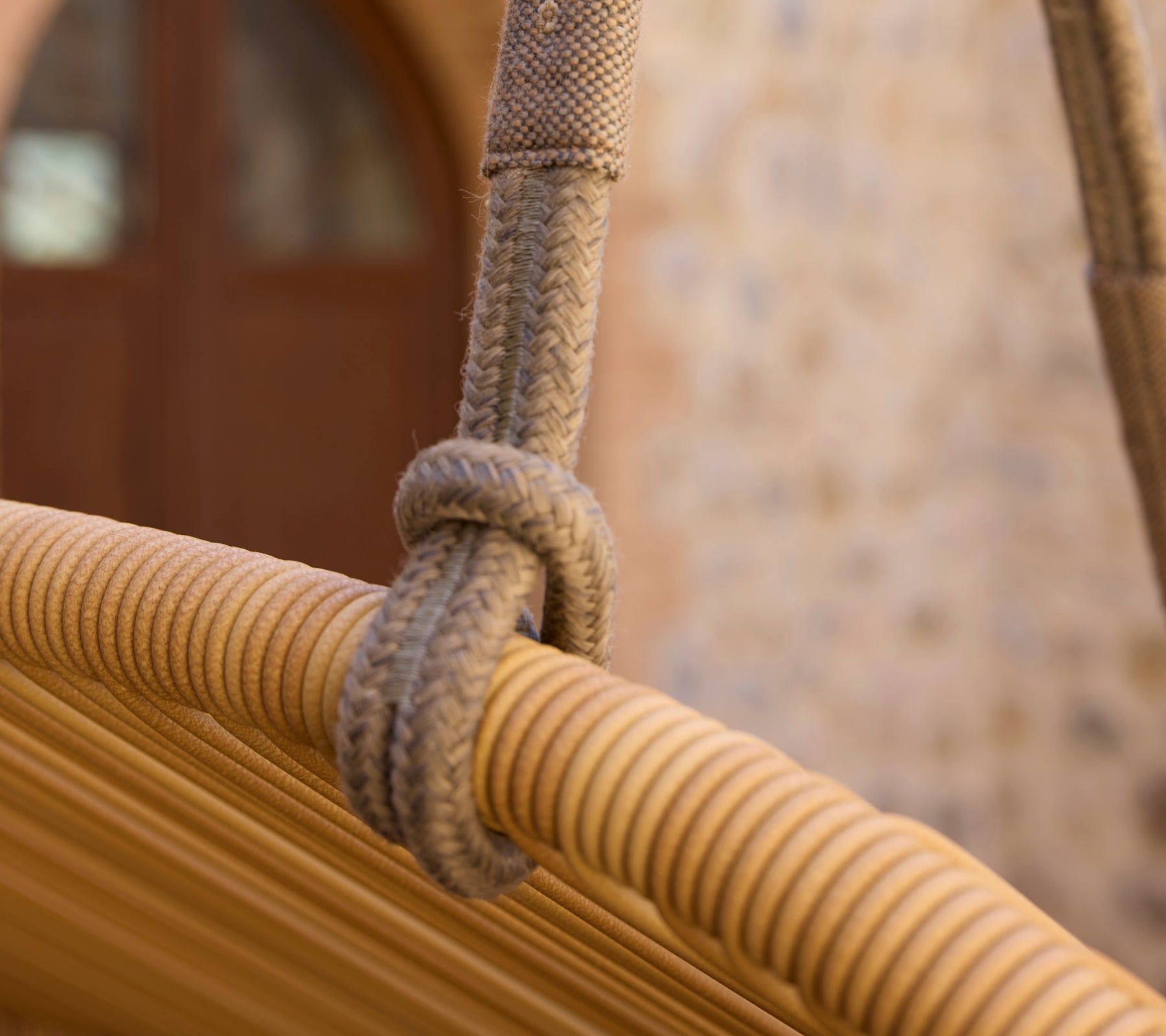 Close-up of a rope knot on a modern Hive sofa, showcasing its woven texture and design details.
