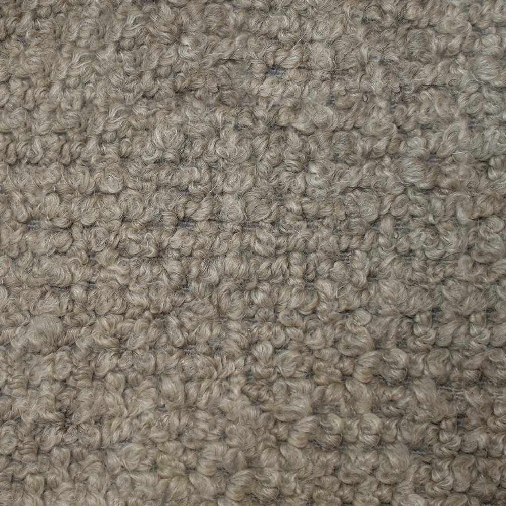 Texturerat beige tyg i närbild.